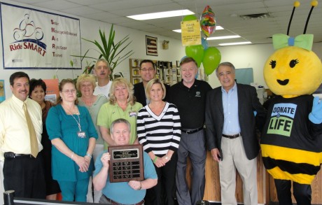 Staff, volunteers pose with award